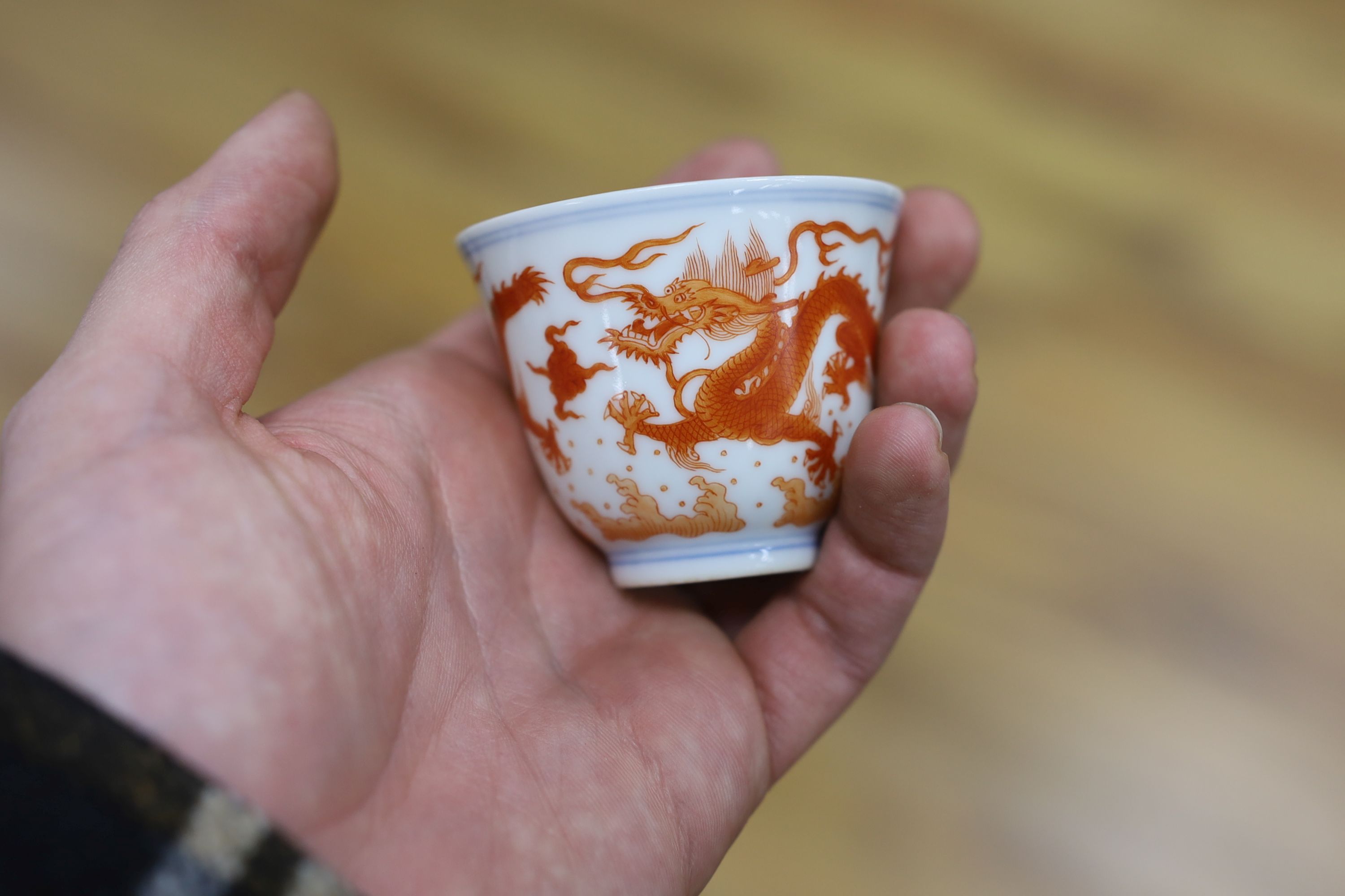 A Chinese iron red enamelled ‘dragon’ tea bowl, 5cm high
